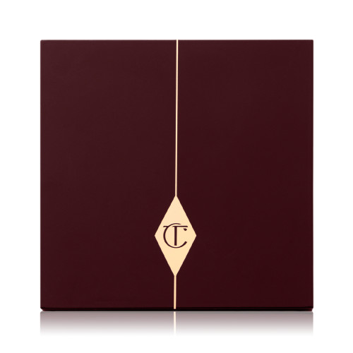 A closed face palette with a dark brown-coloured lid with the iconic CT logo printed on the front in gold colour.