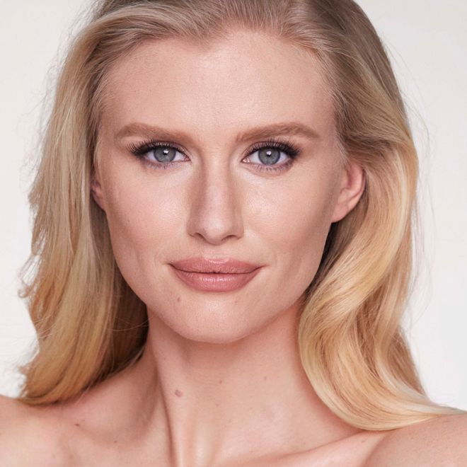 Makeup Starter Kit in Fair on fair-tone model Fair-tone blonde model with flawless, matte skin wearing nude pink lipstick with black eyeliner.