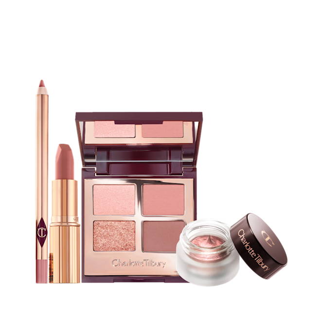 Pillow Talk Romance Box displayed An open lip liner pencil in nude pink, open matte lipstick in nude pink, open, mirrored-lid quad eyeshadow palette with matte and shimmery pink, gold, and brown shades, and open cream eyeshadow pot in rose gold with its lid next to it.