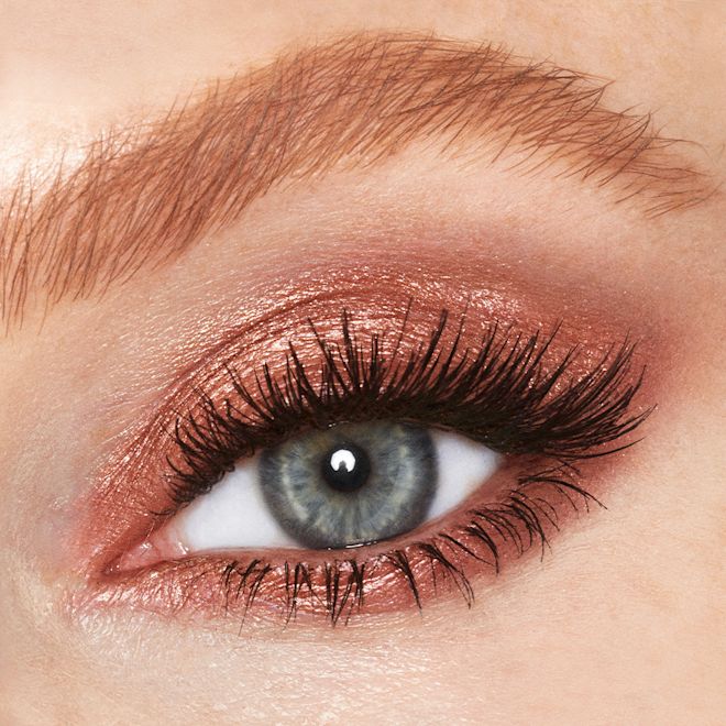 Eyes to Mesmerise in Copper Sunrise on blue eye close-up Single-eye close-up of a single blue eye with shimmery, coppery-gold-coloured cream eyeshadow.