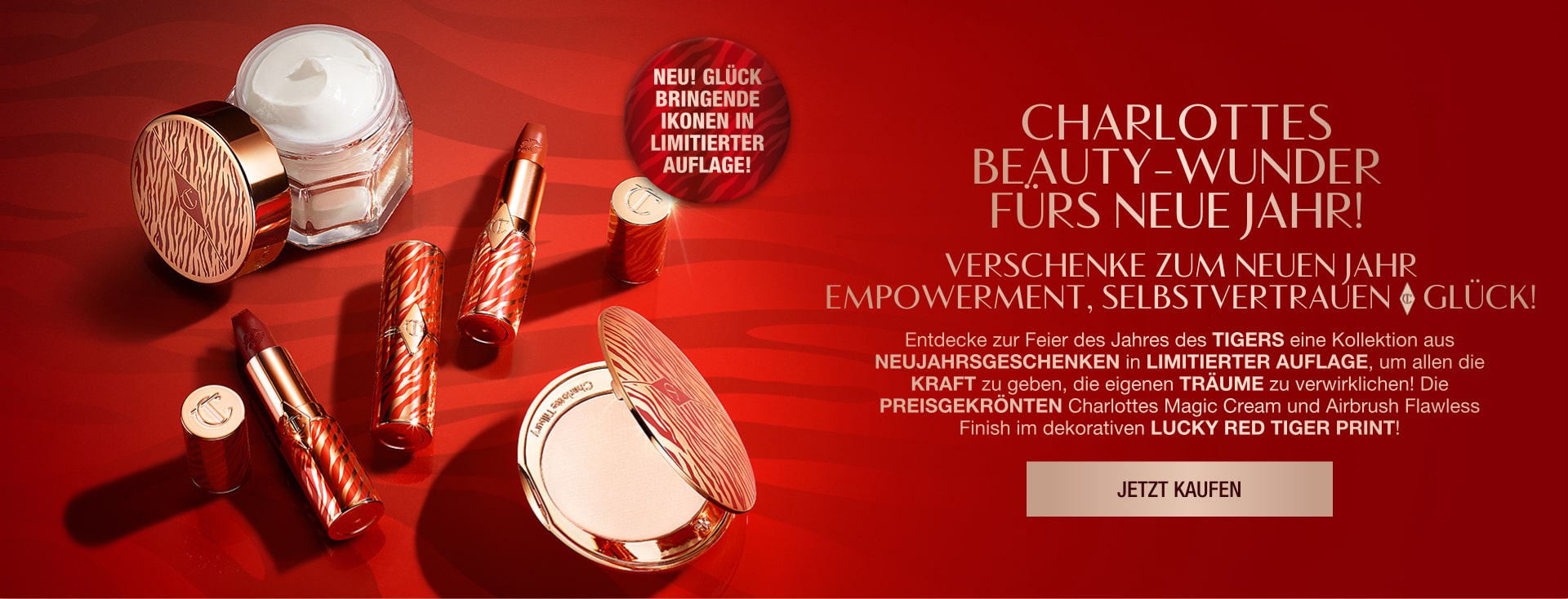 Red-coloured banner with an open jar of pearly-white white cream, open lipstick tubes, and an open pressed powder compact with a mirrored lid in gold packaging, all products having red-coloured tiger stripes on them for the Lunar New Year, along with text on the banner that reads, 'New! Lucky limited-edition icons! gift empowerment, confidence & luck this new year!'