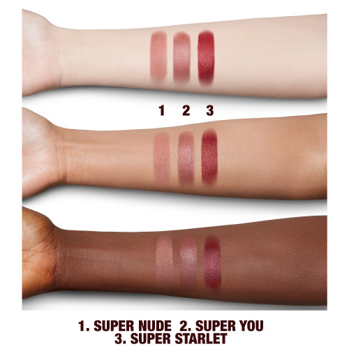 Fair, tan, and eep-tone arm swatches of nude lipsticks in nude peach, nude pinkish-bronze, and shimmery nude scarlett. 