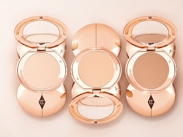 A collection of face powder compacts with mirrored lids in light, medium-light, and medium. 