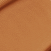 Close-up swatch of a skin-like, glowy foundation in a dark brown shade.