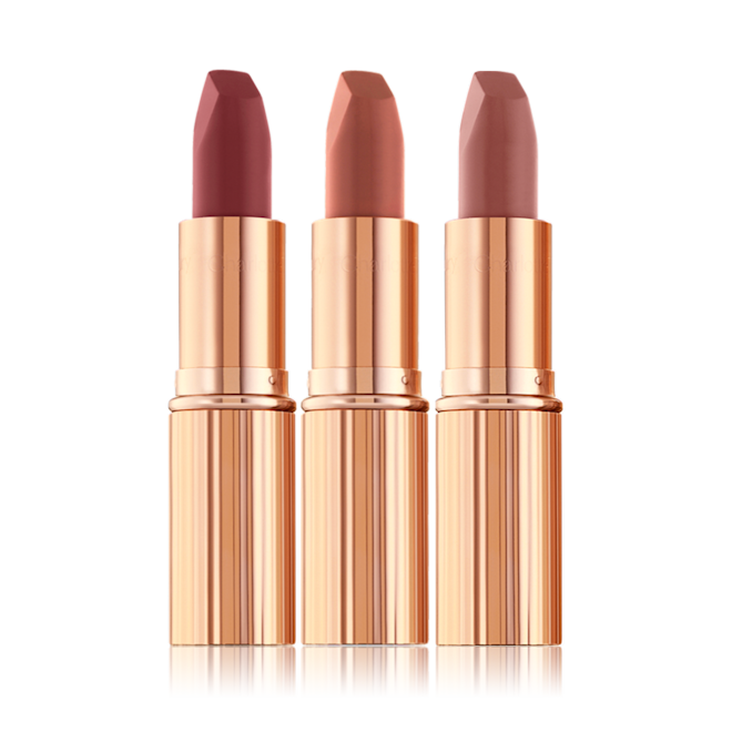 Three open matte lipsticks in nude pink, terracotta, and wine shades.