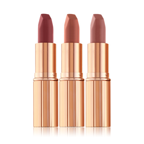 Three open matte lipsticks in nude pink, terracotta, and wine shades.