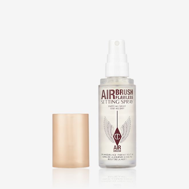 Airbrush Flawless Setting Spray Travel Size lid removed An open, travel-size setting spray in a clear bottle with a gold-coloured lid.