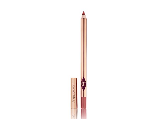 An open, berry-pink lip liner pencil in golden-coloured packaging with the cap next to it. 