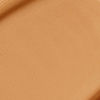 Close-up swatch of a skin-like, glowy foundation in a warm, desert-brown beige shade.