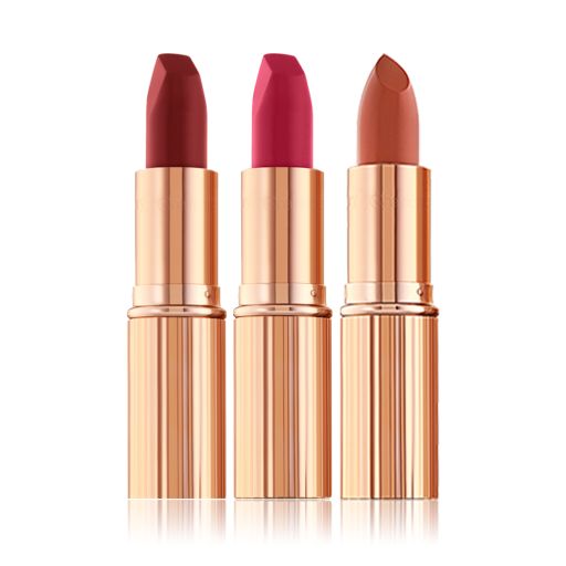 Two matte lipsticks and one satin-finish lipstick in scarlet, fuchsia, and dark terracotta. 