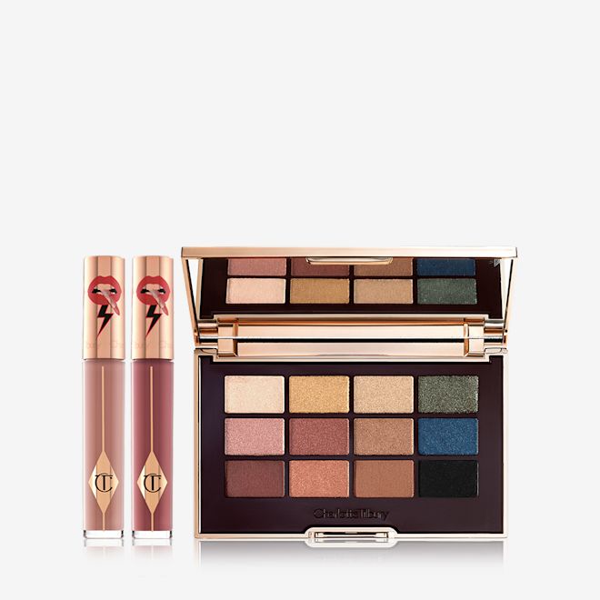 The Icon Eye Lip Duo Day Look kit displayed Two, closed liquid lipsticks in glass tubes in nude shades of brown and red with gold-coloured lids and an eyeshadow palette with matte and shimmery shades of brown, pink, green, gold, blue, and black.