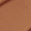 Close-up swatch of a skin-like, glowy foundation in a cool, dark brown shade.