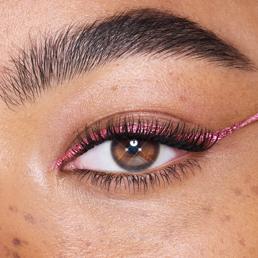 Eye close up wearing metallic pink eyeliner