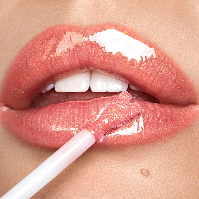 Model lip crop wearing a trending peach lip look using Peachy Plump Collagen Lip Bath