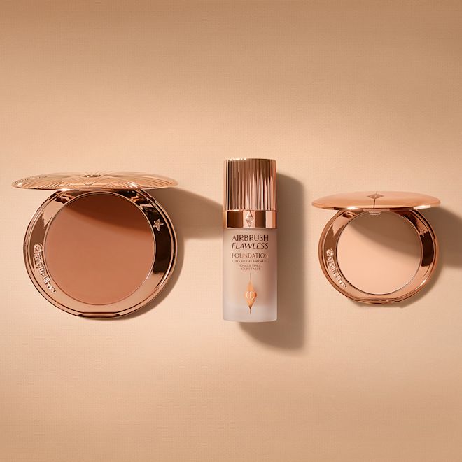 Airbrush Bronzer, Airbrush Flawless Foundation and Airbrush Flawless Finish Bundle open An open, mirrored-lid bronzer compact, light-tone foundation in a frosted glass bottle with a rose-gold lid, and a mirrored-lid light-tone pressed powder compact.
