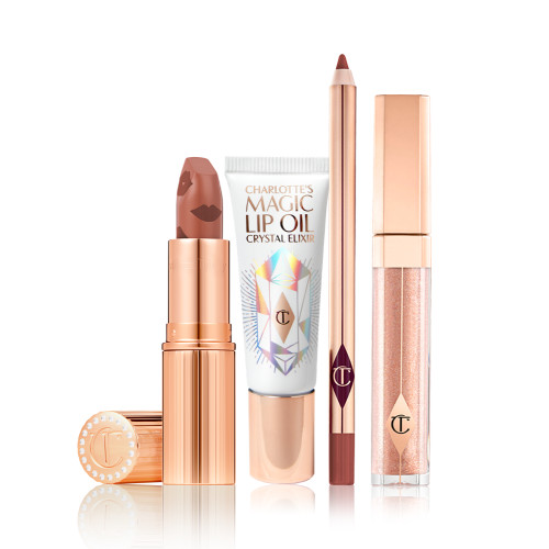 Lip gloss in a nude golden-brown shade in a glass tube with a gold-coloured lid, open nude peachy-brown lipstick in a gold-coloured tube, lip oil in a white-coloured tube with a reflective, geometrical pattern on the front, and a lip liner in a nude terracotta shade.