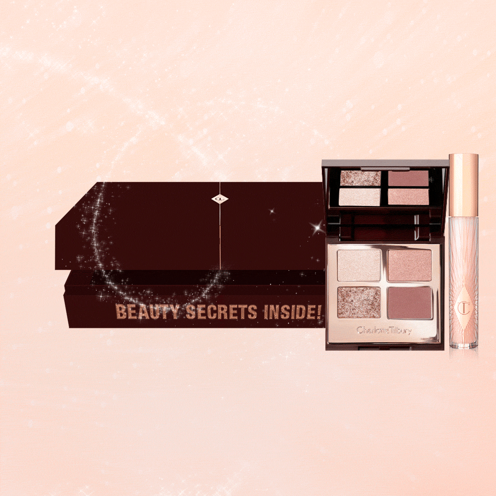 An open, brown-coloured mystery box that contains a sheer pink lip gloss in a glass tube and a quad, eyeshadow palette with a mirrored lid with nude eyeshadows in shades of pink and gold.