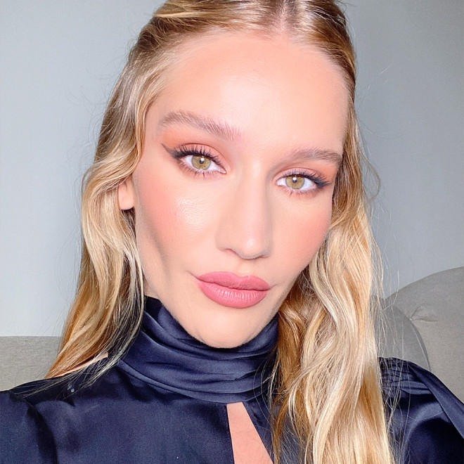 Sofia Tilbury wearing fawn and peach eye makeup with matte nude pink lipstick, and glowy peach blush and black eyeliner with her hair pulled back. 