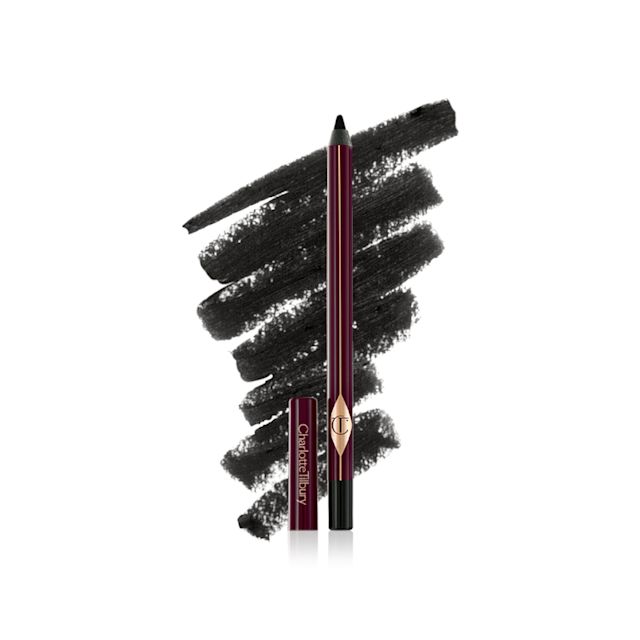 Swatch of a black kohl pencil with the open liner pencil in front of it and its cap next o it. 