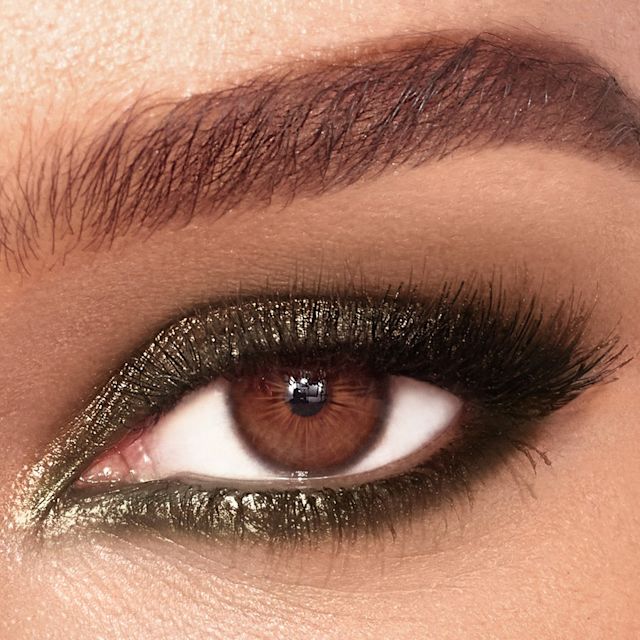 Model wearing Colour Chameleon cream eyeshadow pencil in Smokey Emerald