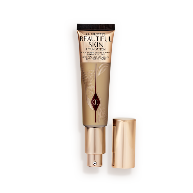 Beautiful Skin Foundation in 6N open An open foundation wand in gold packaging with a pump dispenser and a medium-brown-coloured body to show the shade of the foundation inside.