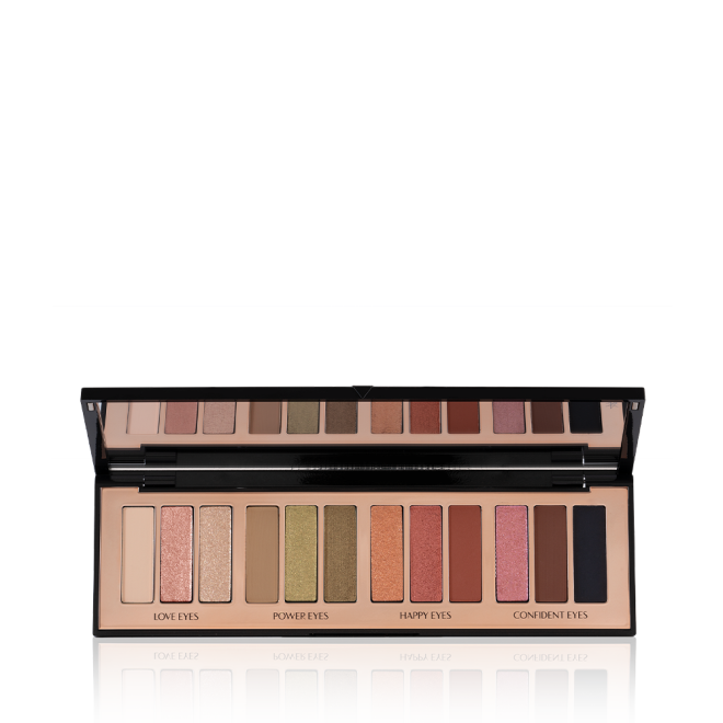 An open, 12-pan eyeshadow palette with matte and shimmery shades in beige, pink, gold, green, brown, peach, and black.