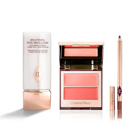 A colour-correcting primer in white and champagne-coloured packaging, a two-tone blush in coral pink, and a lip liner pencil in taupe-brown.