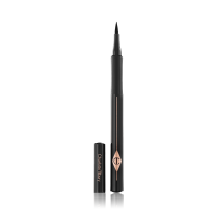 An open eyeliner pen in jet-black packaging with the iconic CT logo embossed on it and its cap next to it. 
