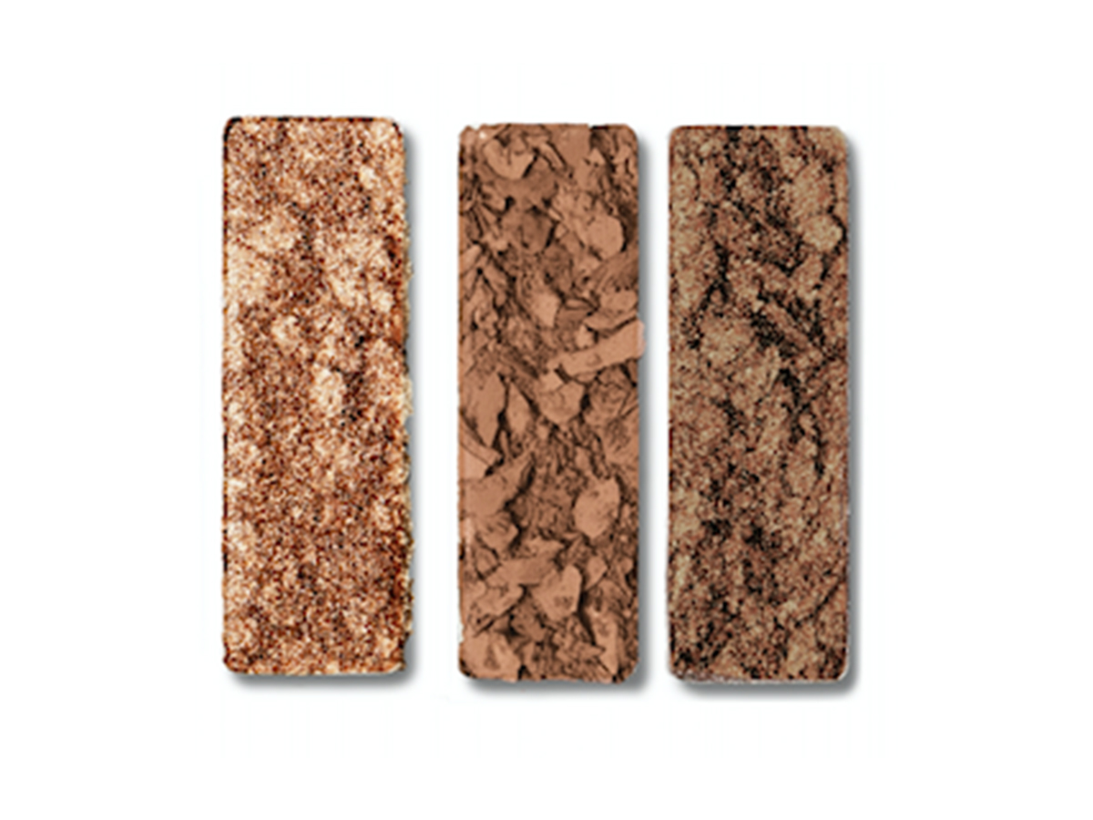 Three shimmery and matte eyeshadows in dark gold, chocolate brown, and coffee brown. 