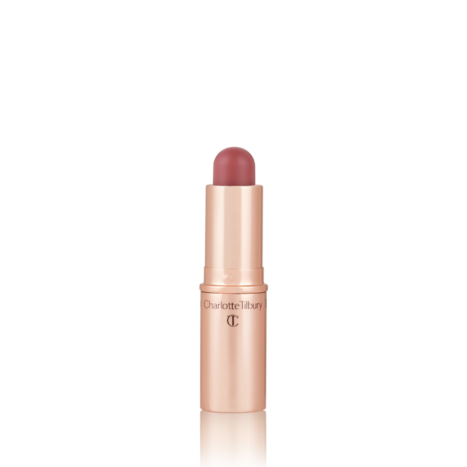 An open, lip and cheek colour stick in a glowy soft pink shade in a golden-coloured tube.