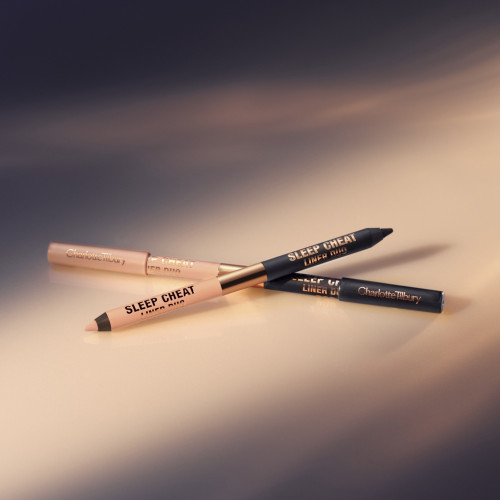 two double-sided eyeliner pencils in jet black and nude beige, with and without lids. 