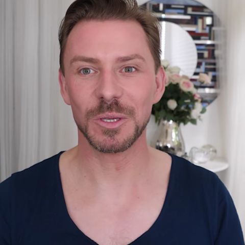 Wayne Goss, a makeup artist, wearing a black shirt with no makeup on. 