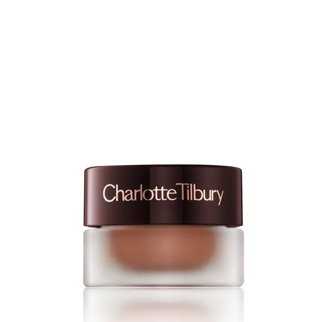 A closed glass pot with shimmery russet rose cream eyeshadow with a golden sparkle with a dark brown-coloured lid.