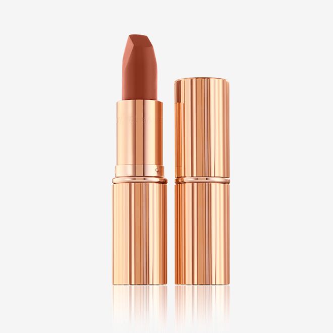Matte Revolution lipstick in Super Fabulous with and without lid Two lipsticks, with and without lid, in a deep, sultry rose-brown nude matte shade, in sleek, gold-coloured tubes.