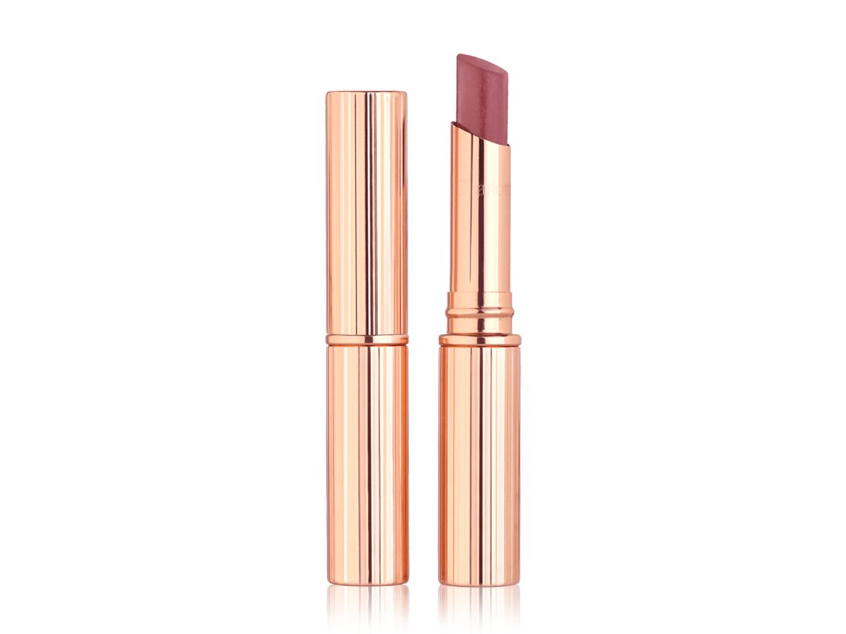 Two glossy lipsticks in nude pink shade, one with its lid and the other with its lid removed, in gold-coloured packaging.