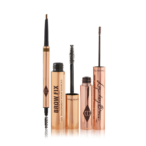 An open, double-ended eyebrow pen and brush, open eyebrow gel, and open eyebrow tint, all in gold-coloured tubes.