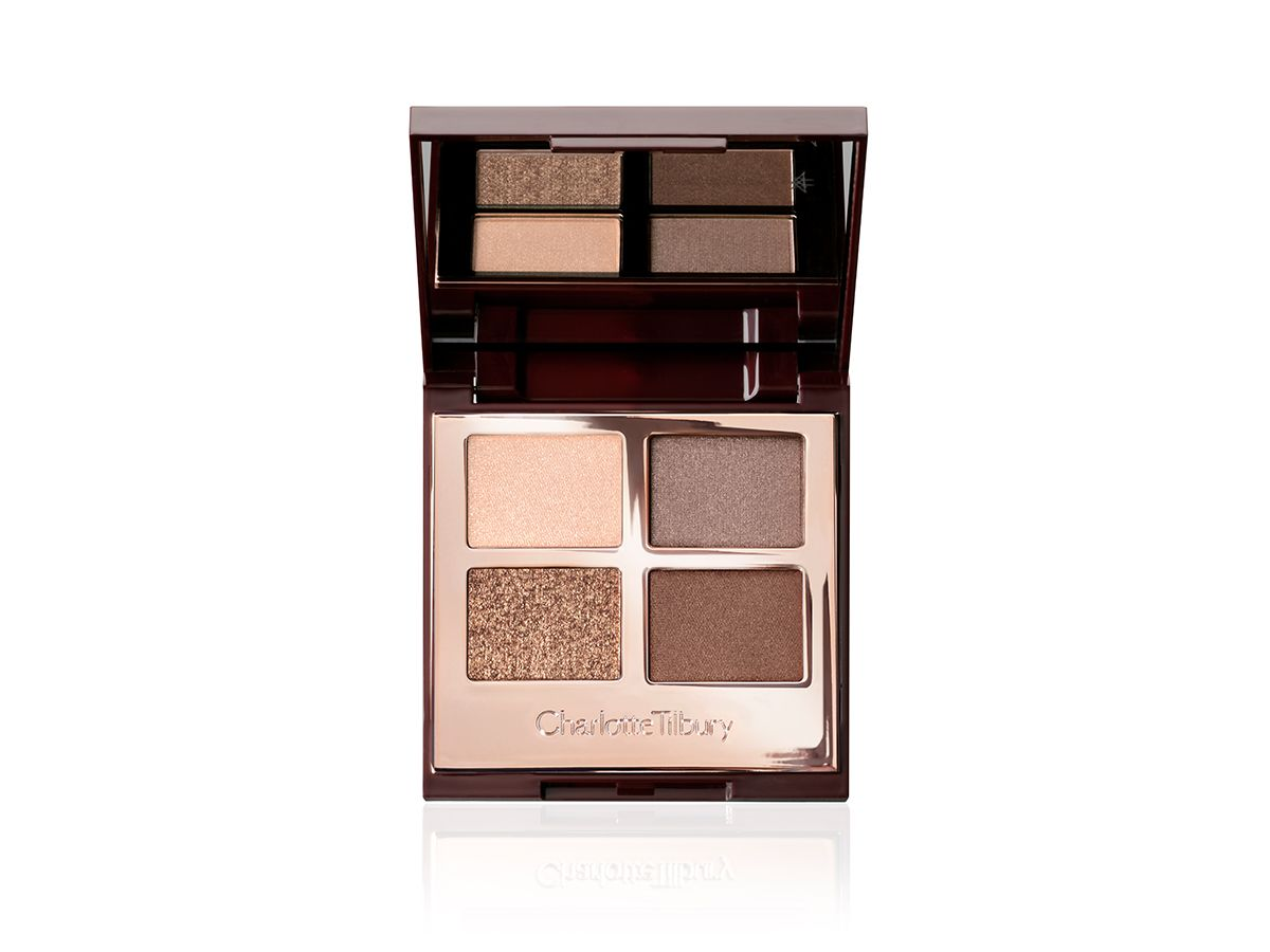 An open, mirrored-lid eyeshadow palette in matte and shimmery gold, brown, and beige shades,