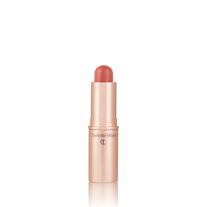 An open, lip and cheek colour stick in a glowy nude rose shade in a golden-coloured tube.