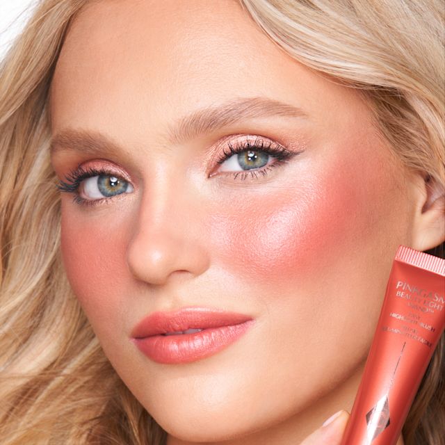 Model wearing a dialled up evening makeup look using Pinkgasm Sunset Beauty Light Wand
