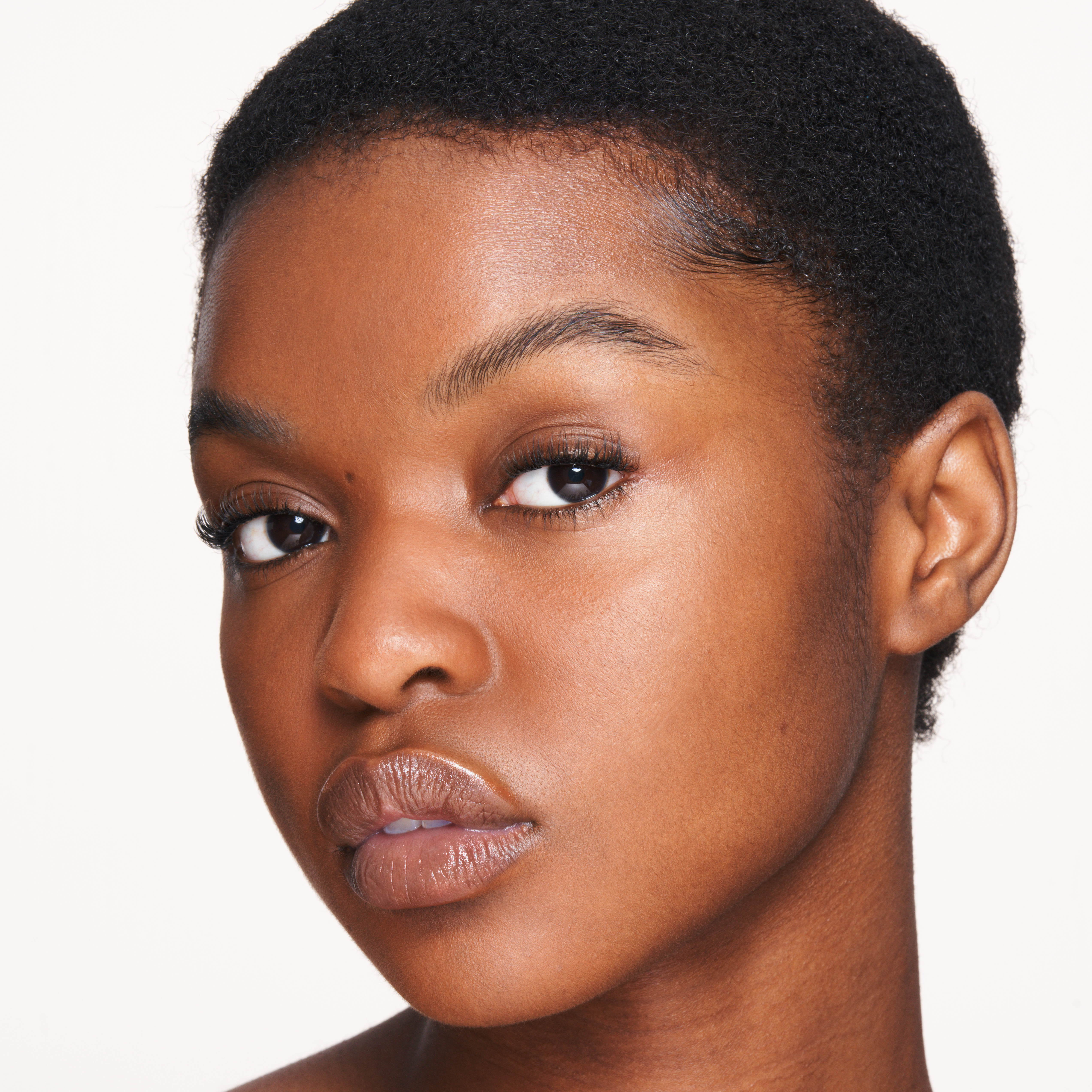 Model wearing Magic Water Cream for hydrated, glowing skin