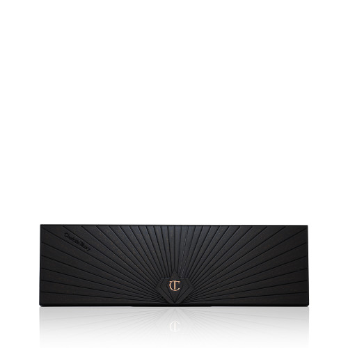 A closed, 12-pan eyeshadow palette with a black-coloured lid with a golden-coloured starburst pattern on the top.