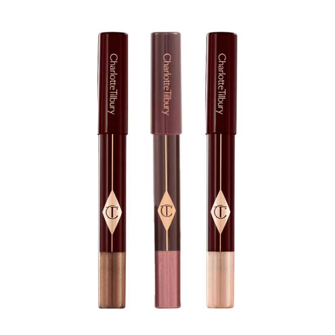 Three, chubby eyeshadow sticks in shimmery shades of purple, bronze, and russet rose.