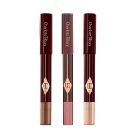 Three, chubby eyeshadow sticks in shimmery shades of purple, bronze, and russet rose.