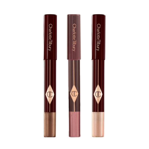 Three, chubby eyeshadow sticks in shimmery shades of purple, bronze, and russet rose.