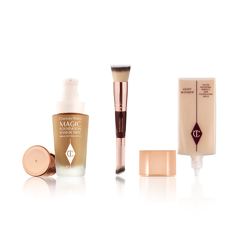 An open foundation in a frosted glass bottle with a rose-gold-coloured lid, a double-sided contour brush, and a foundation in a rectangular bottle with its rose-gold-coloured lid next to it. 