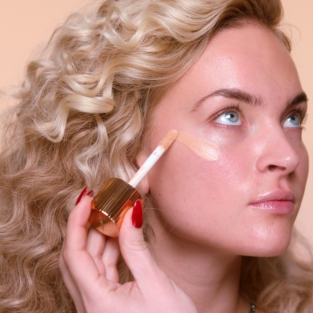 Step 2 in Sofia Tilbury's 80s Makeup Look tutorial: apply Hollywood Flawless Filter