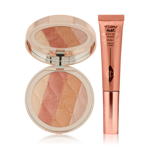 An open highlighter compact with champagne, medium pink, peach, and pearly-pink with a mirrored-lid with a liquid highlighter wand in rose gold. 