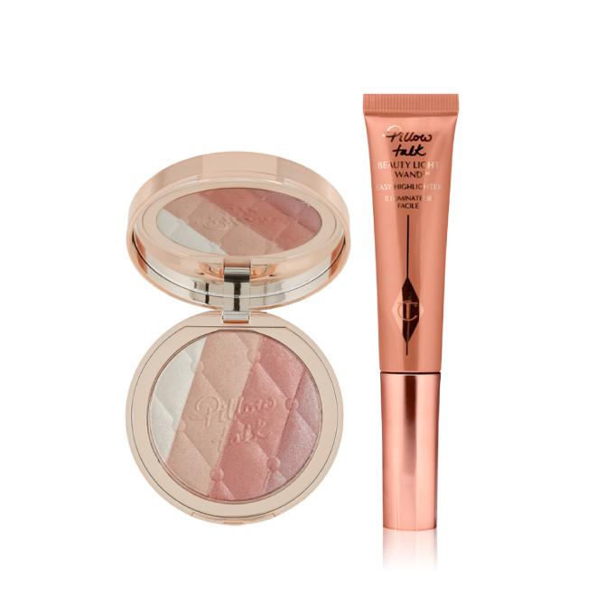 An open highlighter compact with champagne, medium pink, peach, and pearly-pink with a mirrored-lid with a liquid highlighter wand in rose gold. 