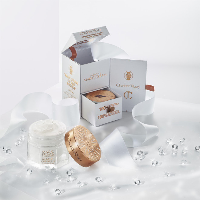 A collection of boxes with full-size face and eye creams in elegant glass jars with gold-coloured lids along with their refills. 
