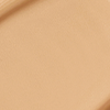 Close-up swatch of a skin-like, glowy foundation in a sandy beige shade.
